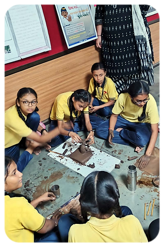 Students shaping clay models in an art activity