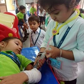 A pre-primary child playing doctor with a first-aid kit
