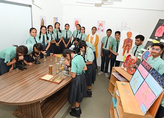 Students at the microscopes in the biology laboratory