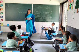 A primary class answering questions during a lesson