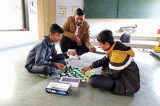 Students playing chess in the sports room