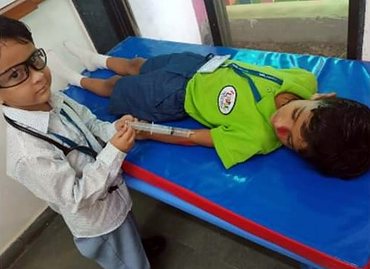 Little doctors caring for a patient on role-play day