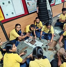 Students shaping clay models in an art activity