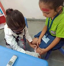 Little doctors caring for a patient on role-play day