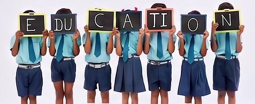 Students spelling out EDUCATION with slates