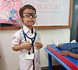 A pre-primary child dressed as a doctor on role-play day