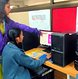 A teacher guiding a student in the computer lab