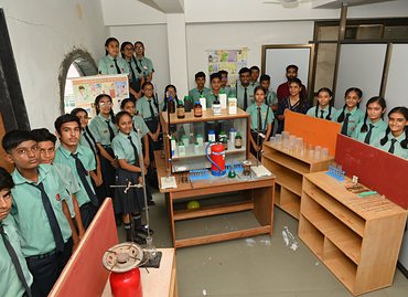 Senior students with their teacher in the chemistry laboratory