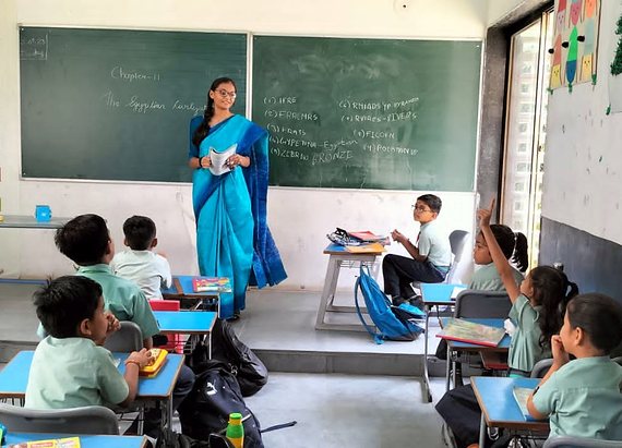 A primary class answering questions during a lesson