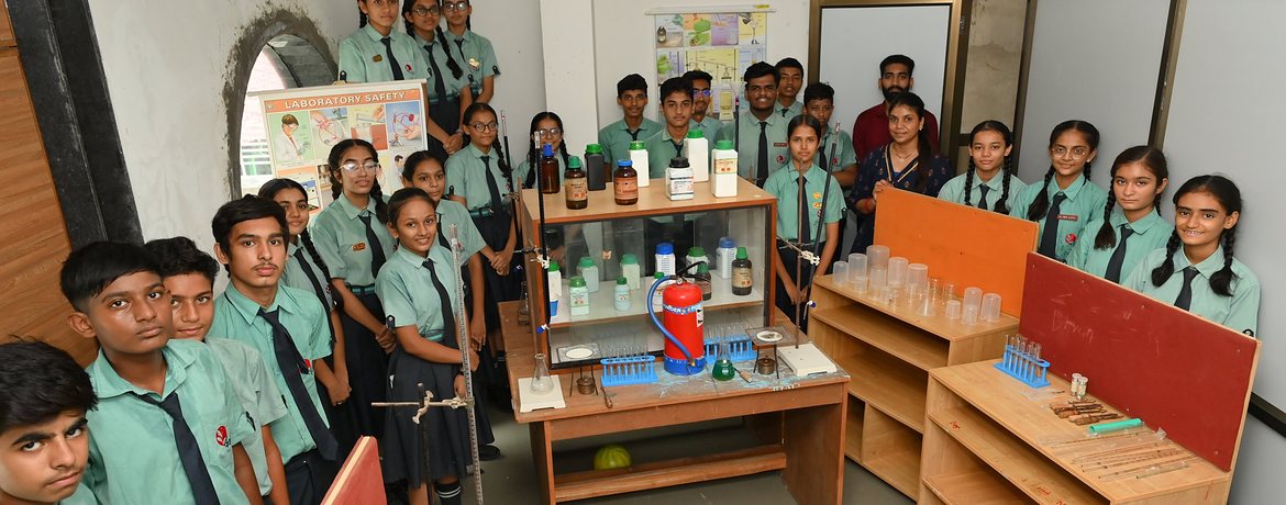 Senior students with their teacher in the chemistry laboratory